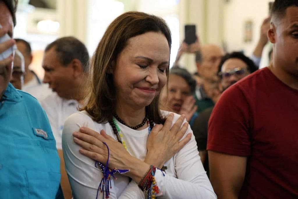 María Corina Machado cumprimentada por apoiadores ao chegar a uma igreja na Venezuela